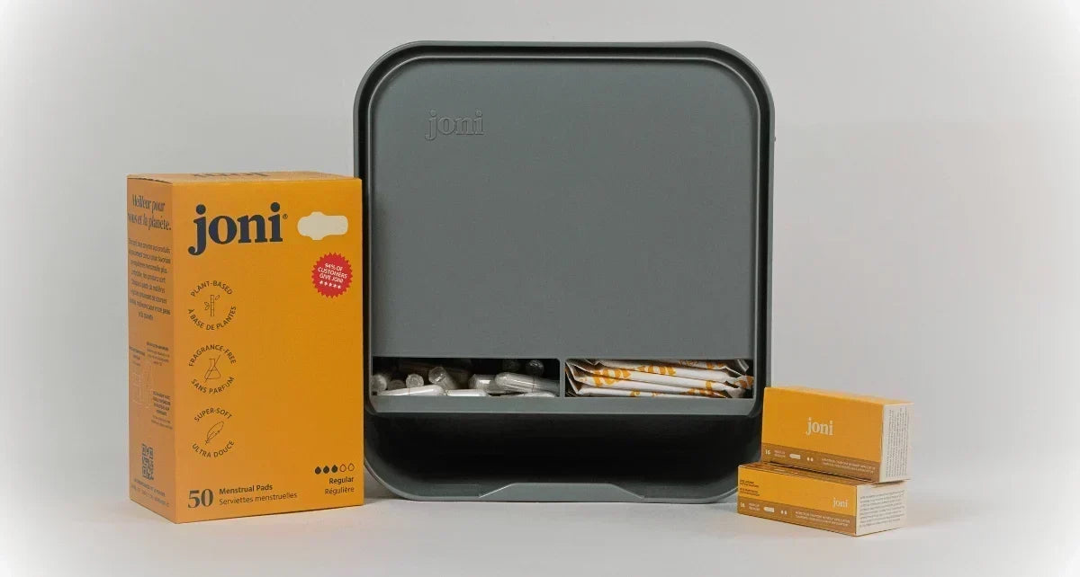 JONI Model A dispenser on counter with regular pads and tampons