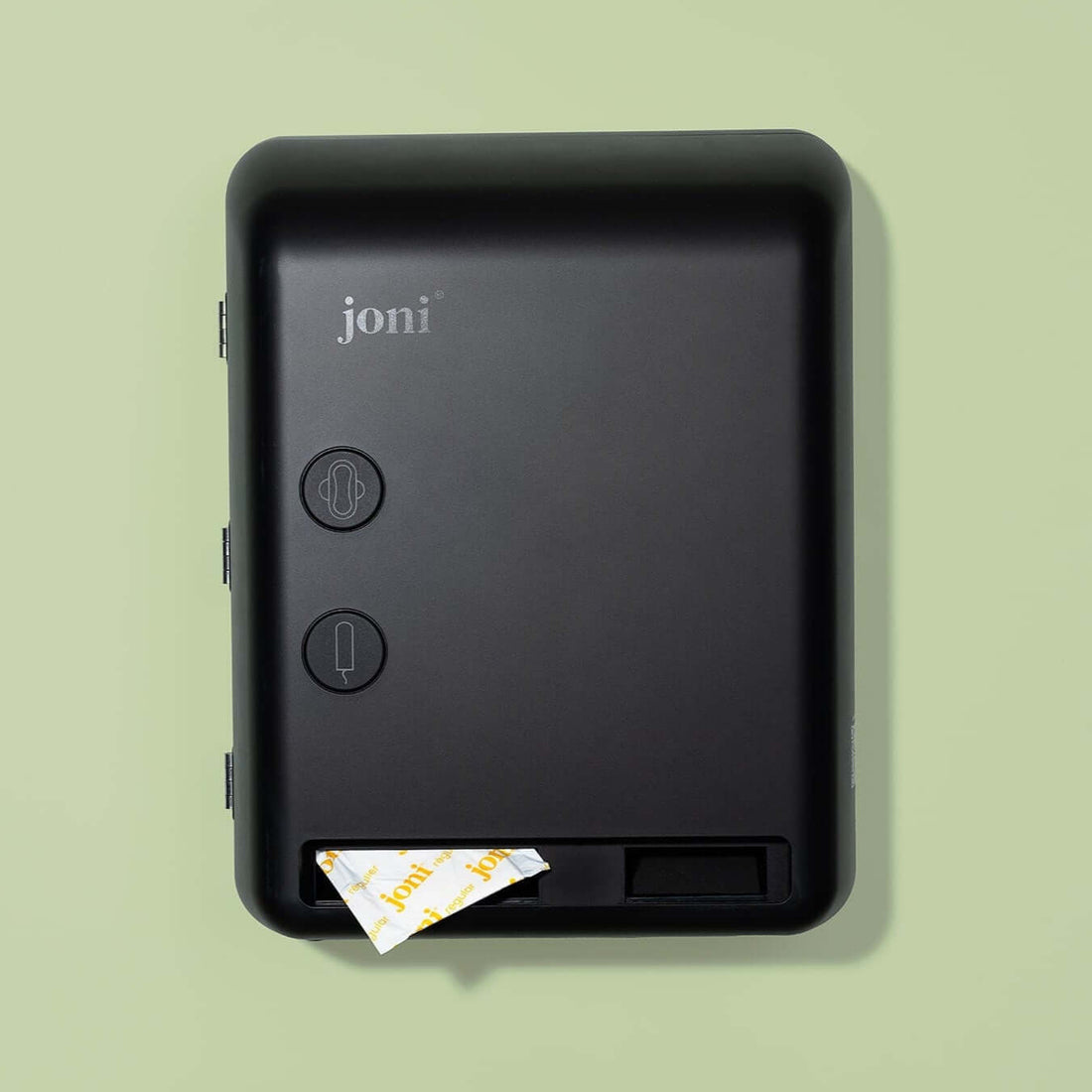 joni period care dispenser on a green background with a product dispensing from the base