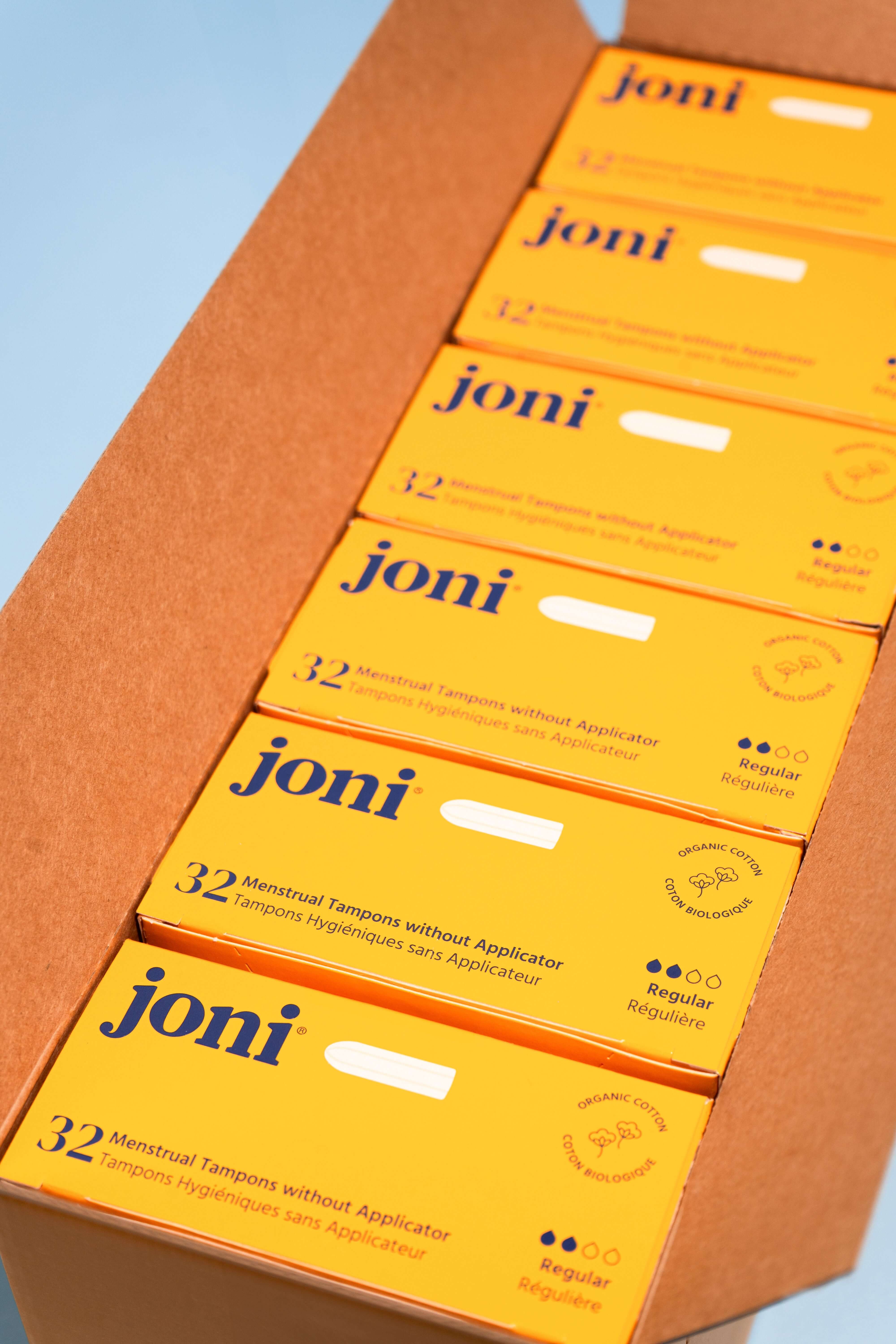 Open casepack of joni regular tampons for commercial washrooms with a blue background