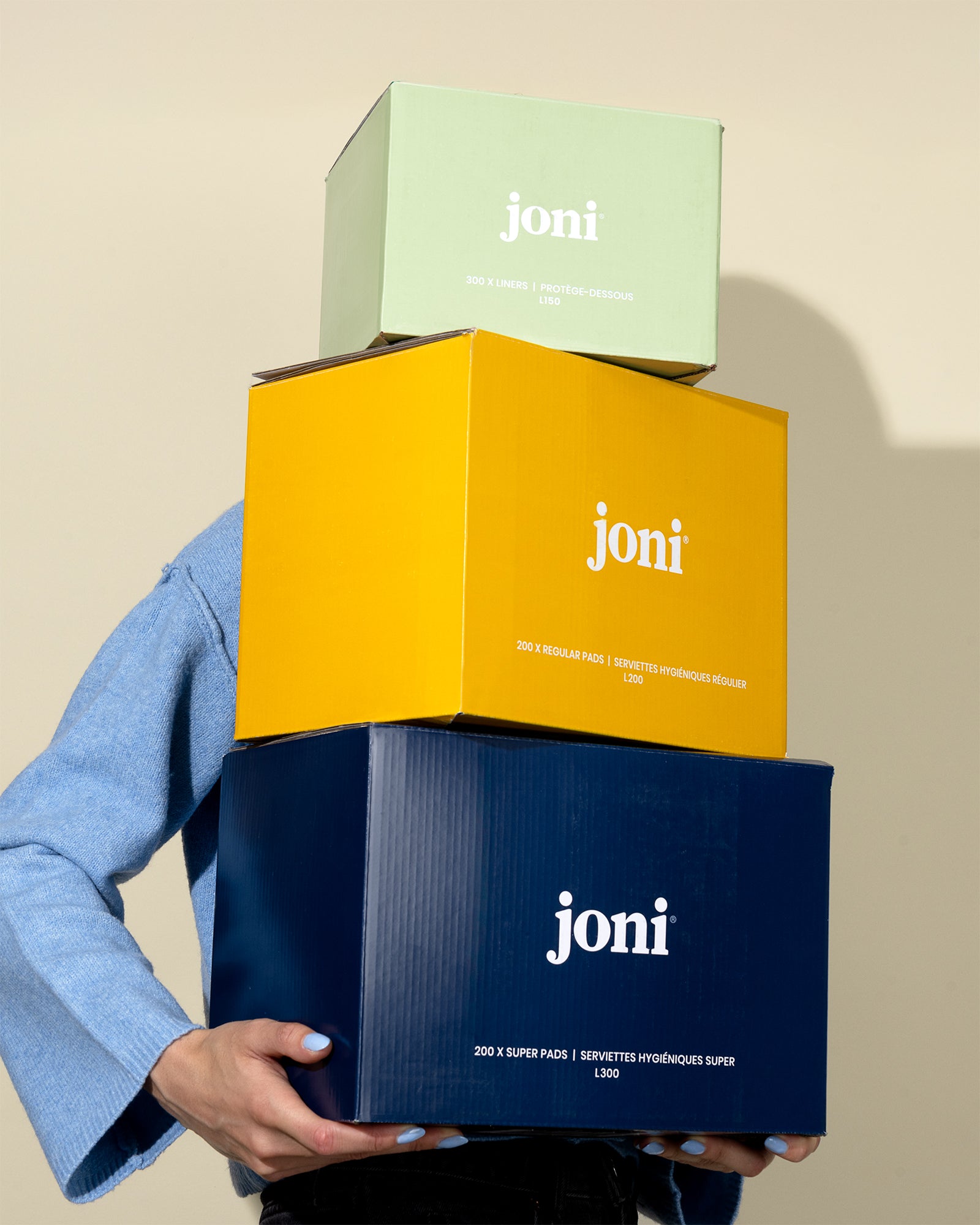 Three 'joni' boxes stacked on a beige background